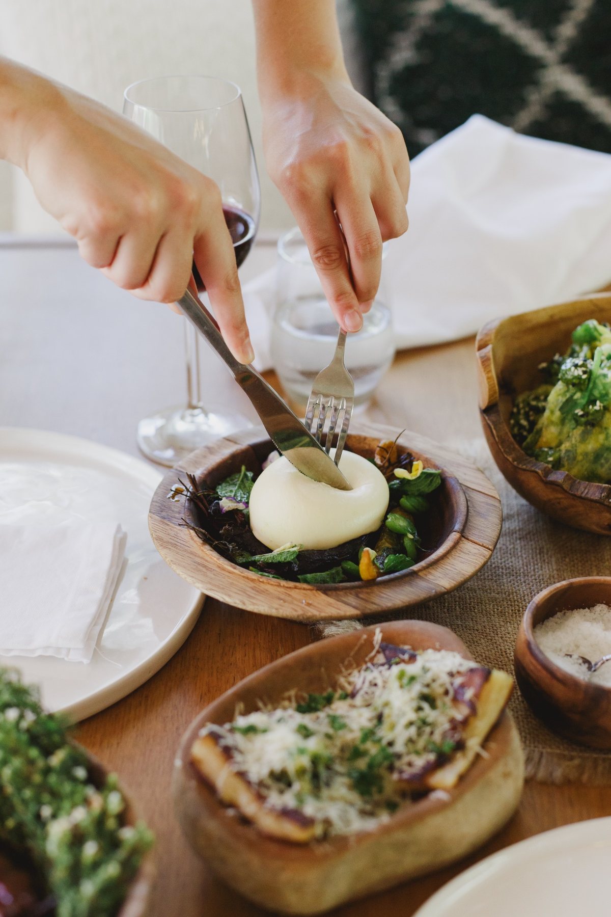 Fresh cheese being shared with vegetables at Melfort’s table